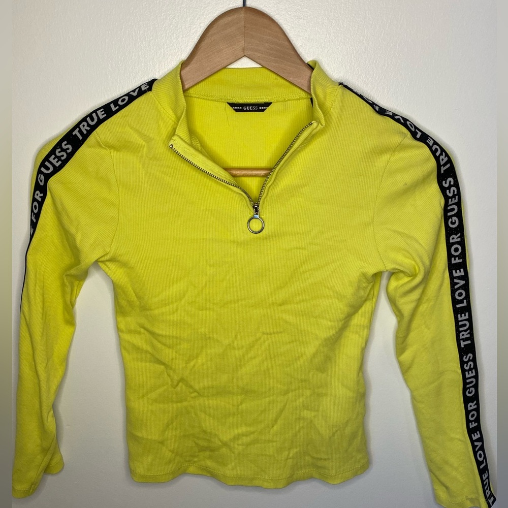 Neon green top with letter detailing on the sleeves